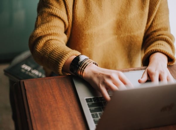 Business planning : Woman sat typing on laptop_Photo by Christin Hume on Unsplash