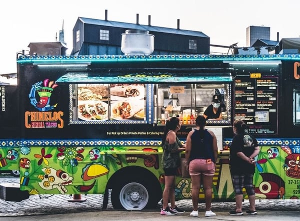 People standing outside taco truck_Photo by Harry Gillen on Unsplash