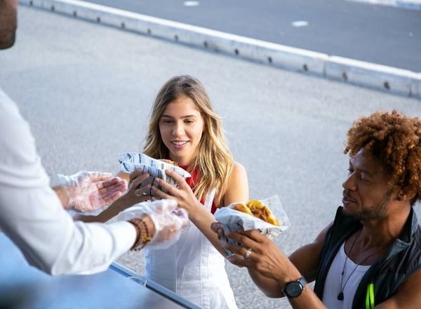 Man and Woman receiving burgers from a food truck_Photo by Kampus Production from Pexels