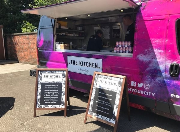 Outdoor branding ideas: Branded food sampling van with two A poster frames outside