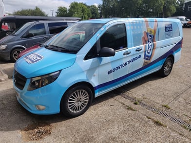 A blue van wrap for the Boost brand.