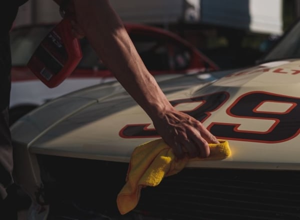 Drying car with microfibre cloth after washing it - Photo by Matthew Dockery on Unsplash