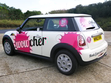 A white and pink car wrap design for Wowcher.