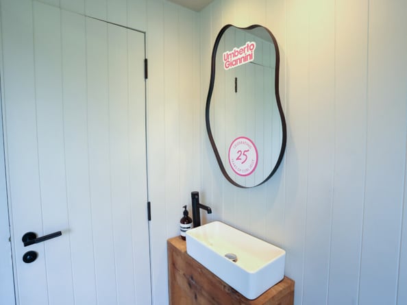 A vinyl sticker on a mirror in London for Umberto Giannini