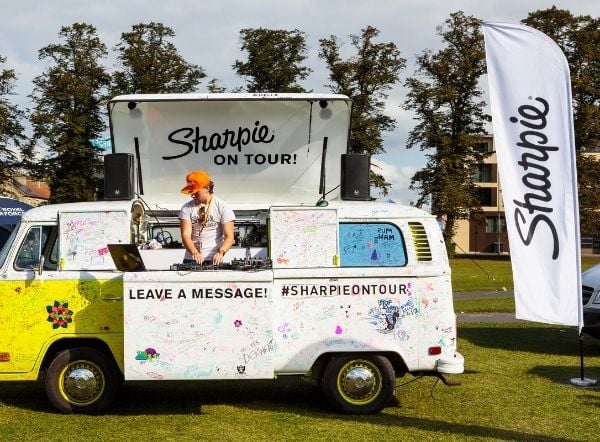 Sharpie flag next to branded camper van