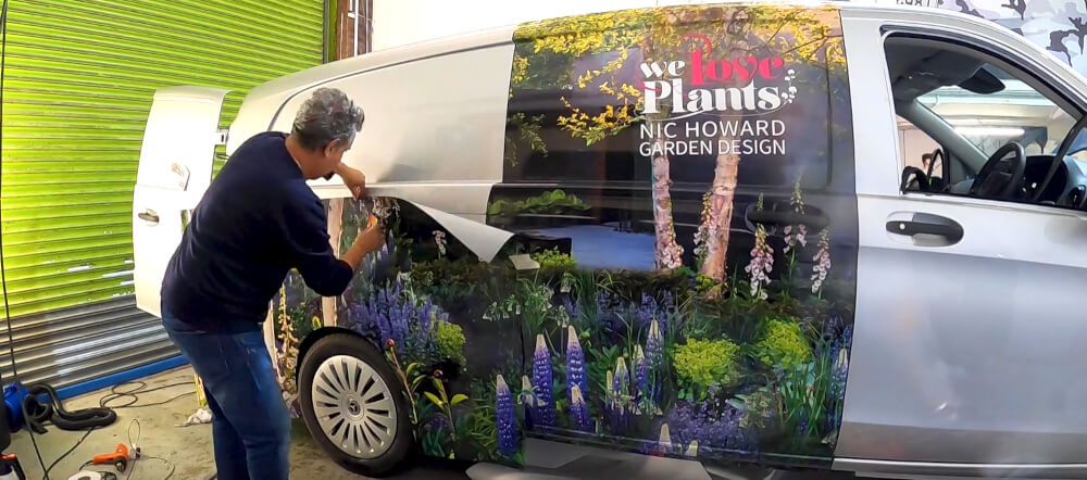 Wrapping a vehicle in PVC-free film for sustainable vehicle graphics.