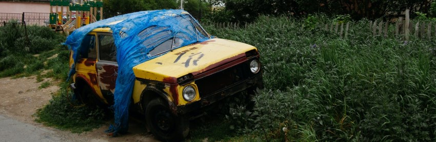 rusted-yellow-car-wrapped-in-decayed-vinyl-blue