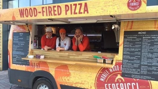 Chefs standing in pizza street food truck