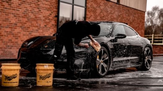 Hand washing sports car as part of vehicle wrap aftercare - credit Brad Starkey from Unsplash